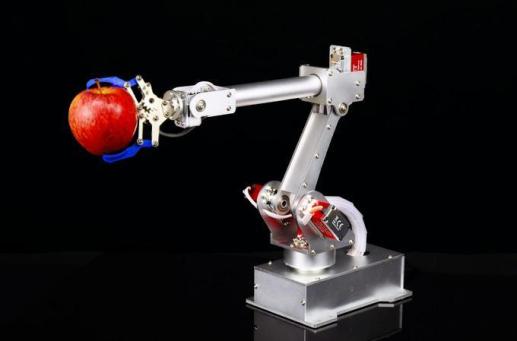 wrenches_a robot is holding an apple